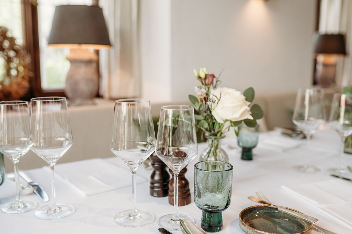 Nehaufnahme von Hochzeitsfotograf Rosenheim von Weingläsern und Blumendekoration auf einem Hochzeitstisch
